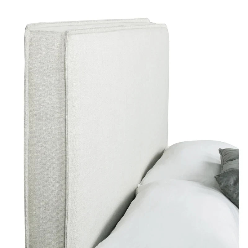 Tête de lit tapissée couleur sable avec détails à bride